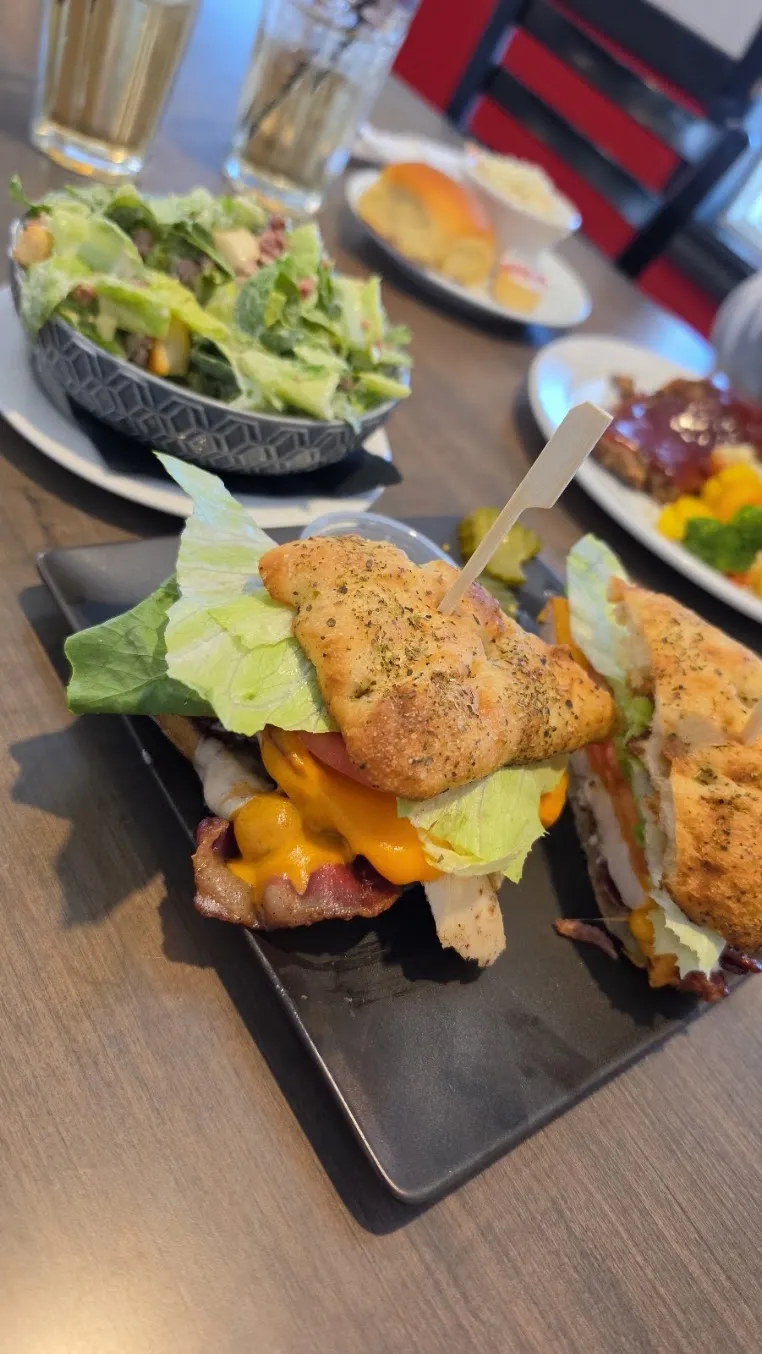 A chicken burger with a side salad