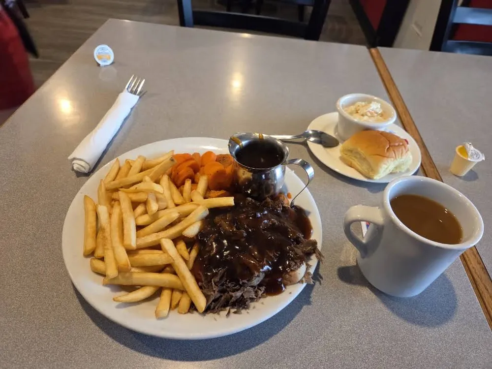 A hot beef plate with gravy and fries