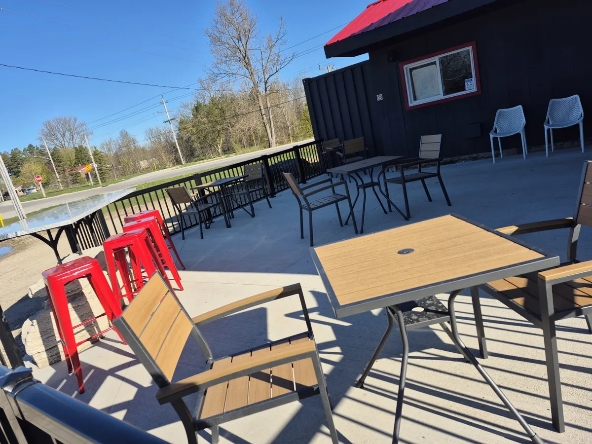 The patio with red stools